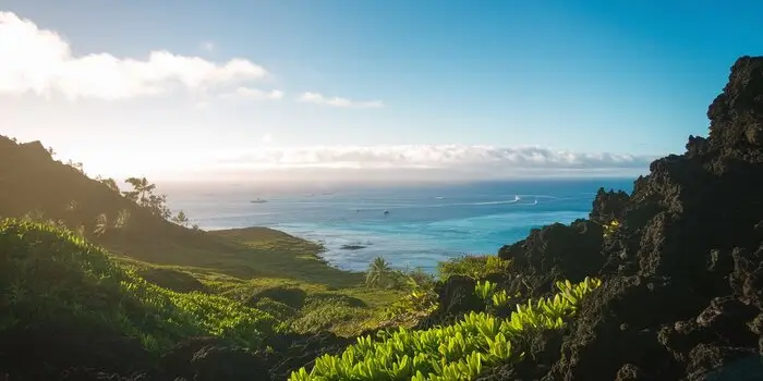 A scenic view of Maui, Hawaii, featuring turquoise waters, golden beaches, and lush green mountains.